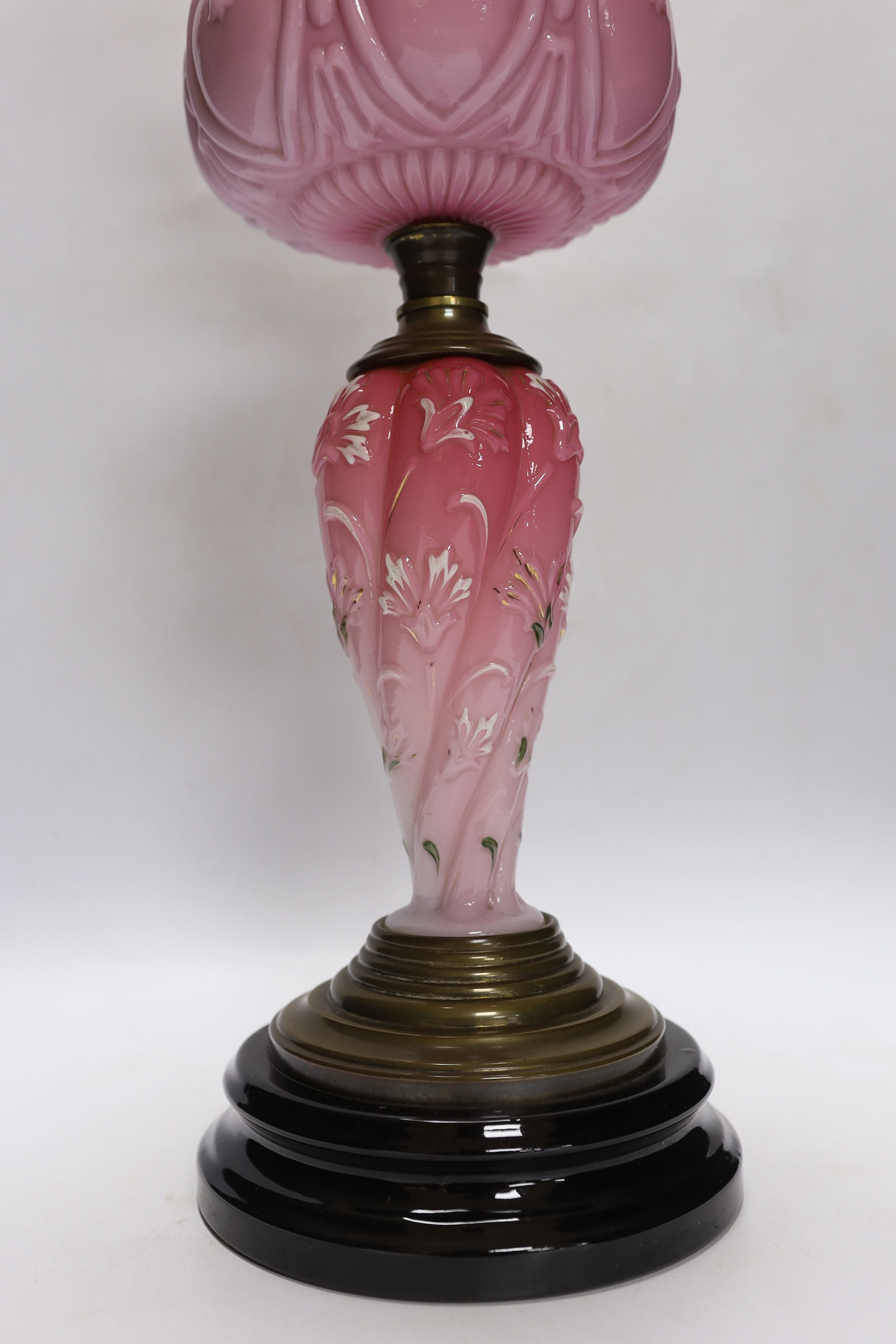 A late 19th century pink and white glass oil lamp, 73cm high